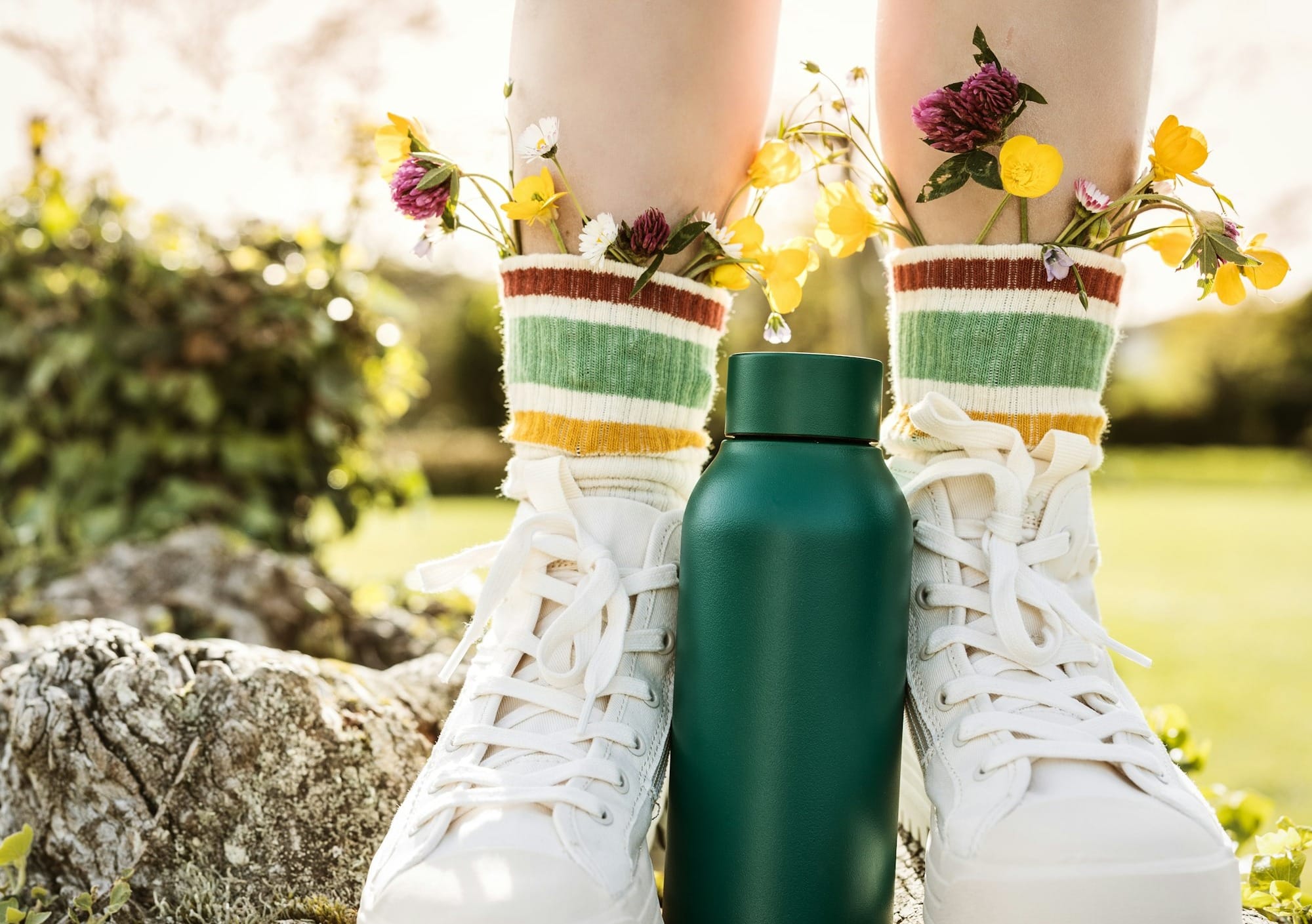 person wearing white and yellow floral rain boots